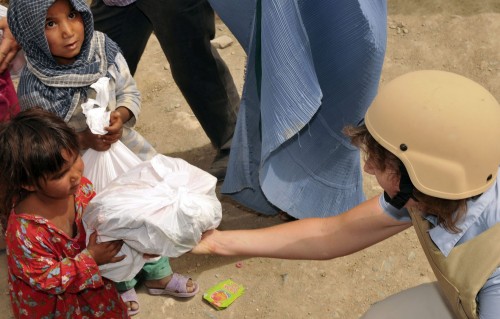 KABUL, Afghanistan- An Afghan girl accepts a bag of supplies from a volunteer from the International Security Assistance Forces Headquarters at a Humanitarian Aid effort held at an Afghan Refugee Camp July 15, 2010. ( Photo by U.S. Air Force Senior Airman Tania Reid)